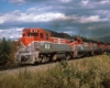 Six red, gray, and black diesel Bangor Aroostook locomotives on train in wilderness