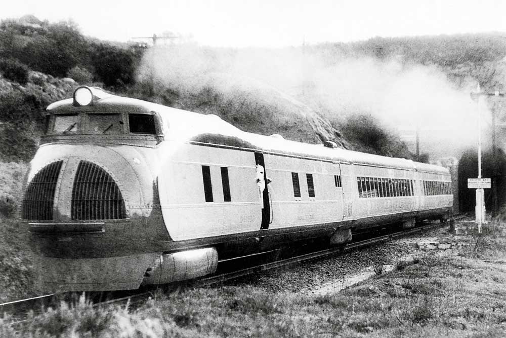Streamlined diesel locomotive exiting tunnel
