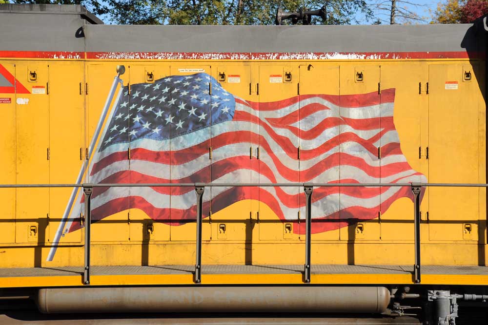 American flag decal on side of Union Pacific Armour yellow locomotive