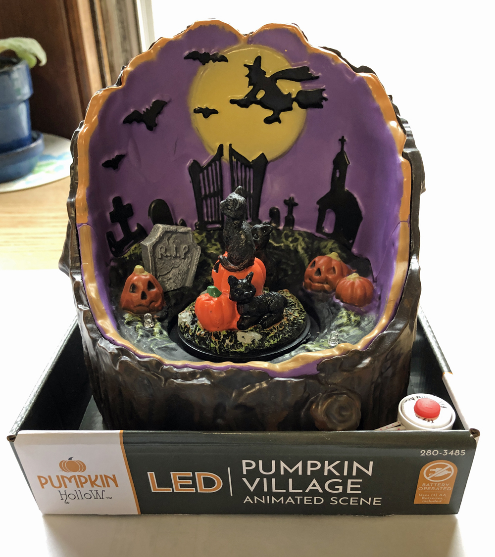 An easy Halloween project involves this decoration with cats and pumpkins