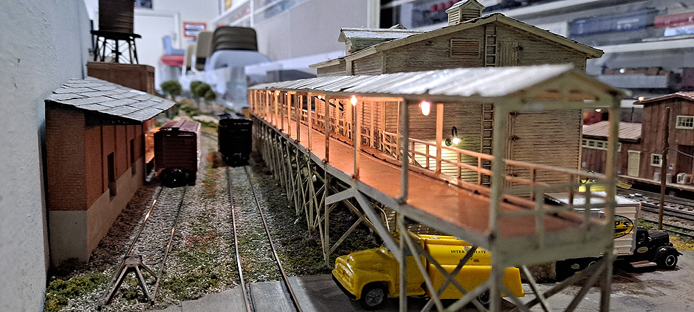 Two parallel spurs lead off to background, packing house to left, icing dock and icehouse to right