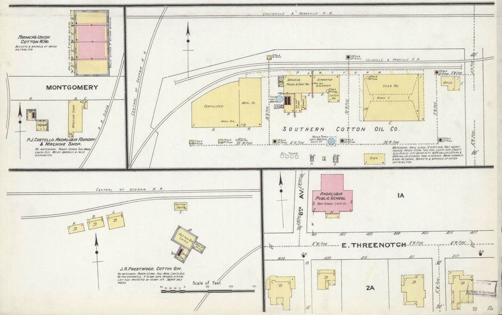 A portion of a hand-drawn map from 1910 showing buildings, streets, and railroad lines