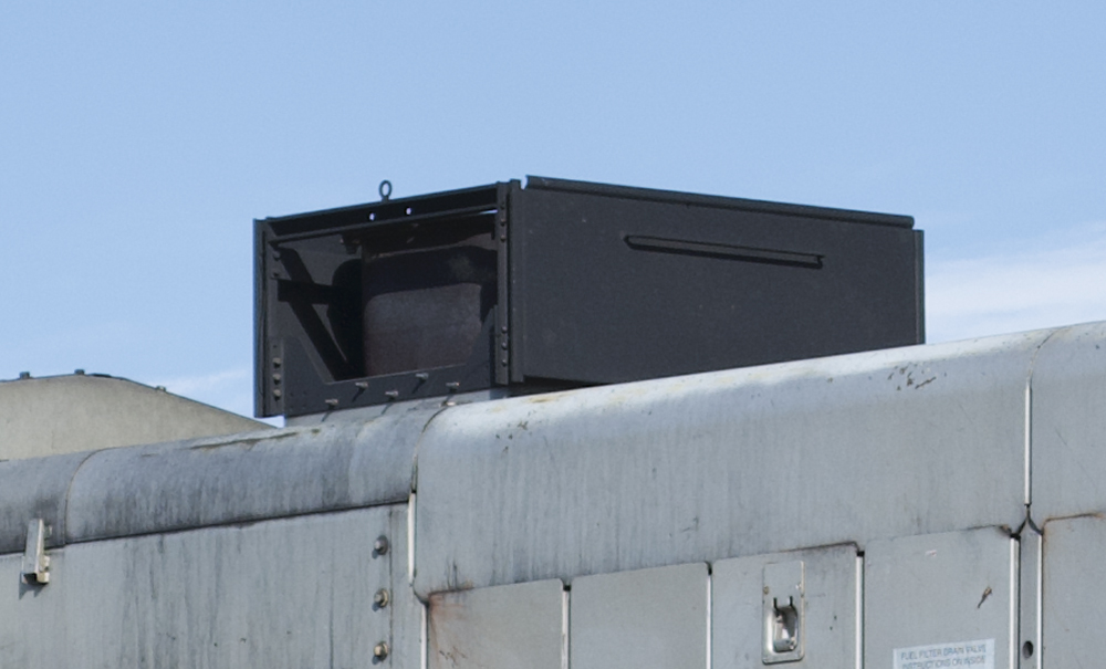 Close-up photo of metal box around exhaust stack