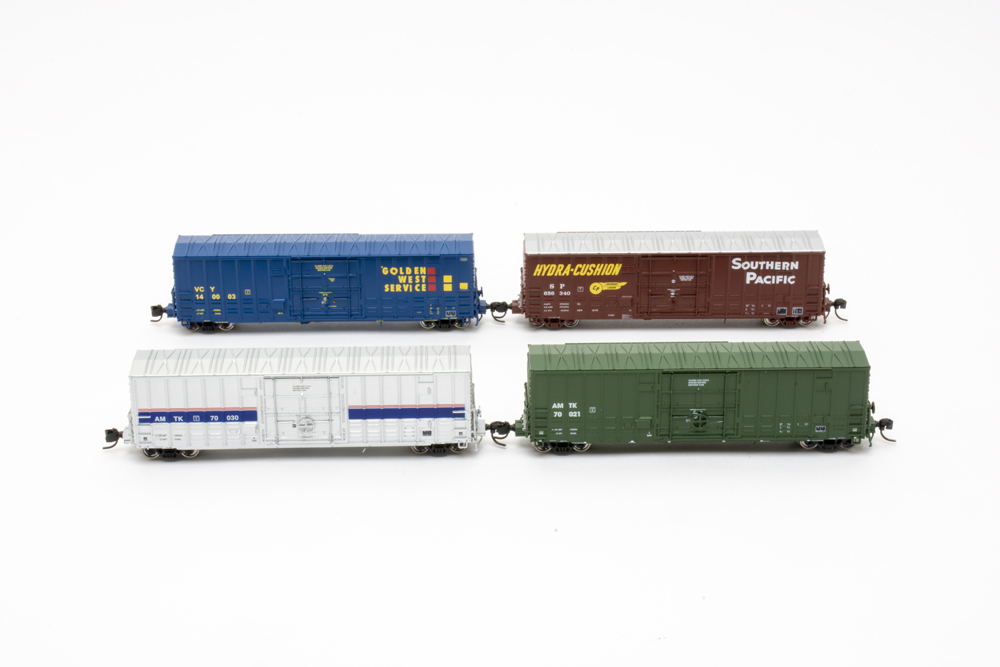 Models of four boxcars with white background