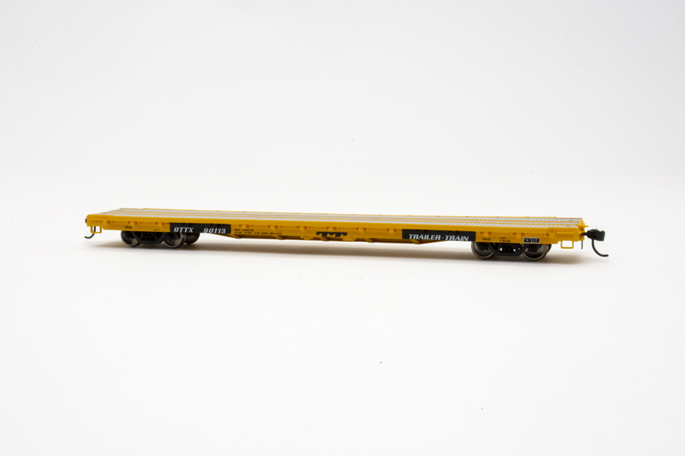 Model of yellow flatcar with white background