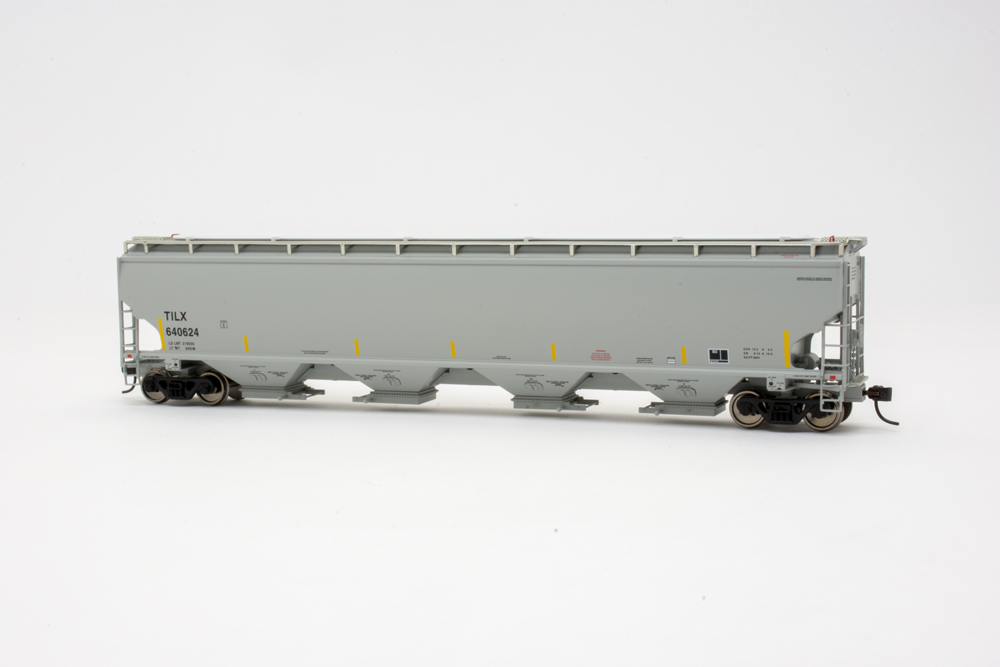 Model of gray hopper car in front of white background