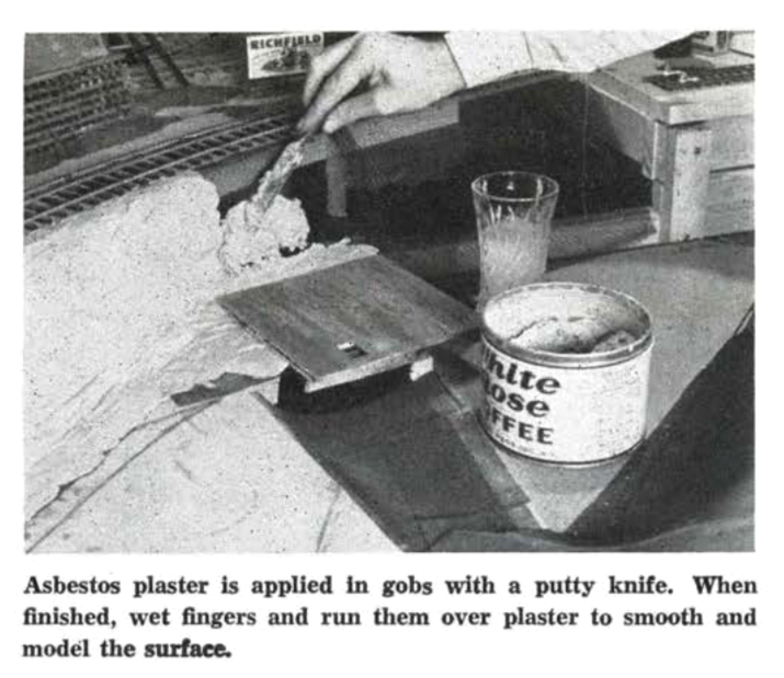 black and white photo of hand applying asbestos plaster