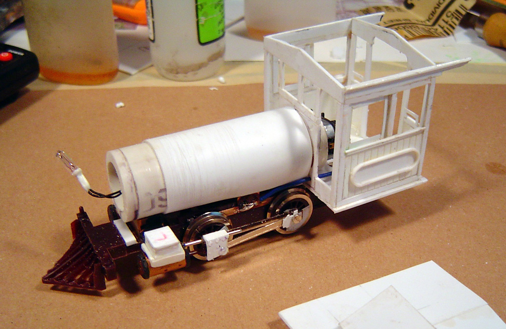 Boiler and white plastic cab added to model locomotive chassis