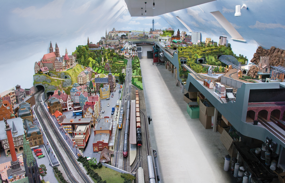 Overview shot of long train layout with scenes from Europe.