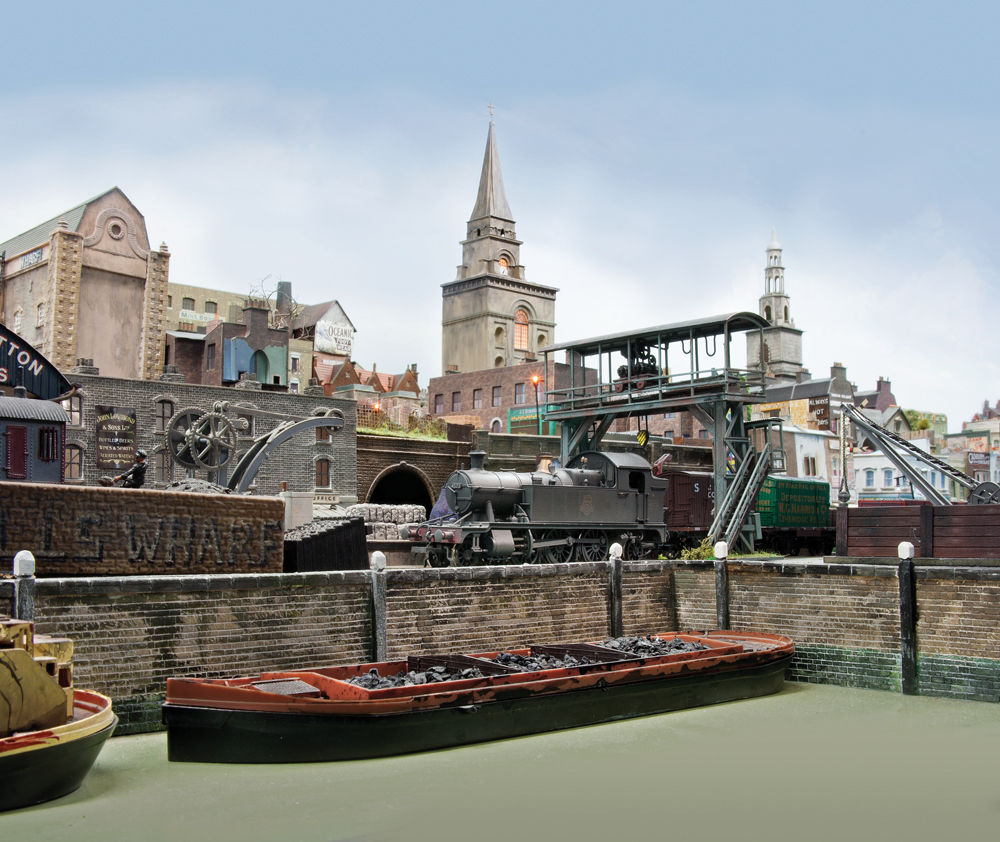 A small steam engine switches cars right above a barge in a wharf.
