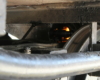 A look under a steam locomotive showing fire in firebox.
