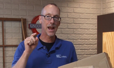 Man gesturing in a basement.