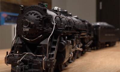 Close-up view of a black toy steam locomotive on display on a table.