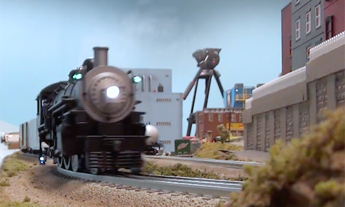 Motion blurred toy train locomotive rounding a curve.