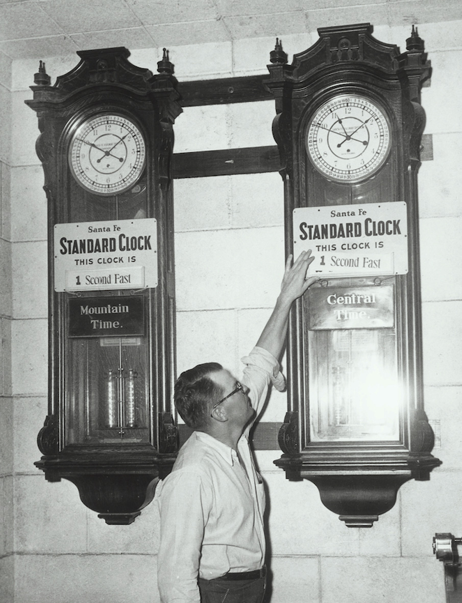 guy looking at two clocks