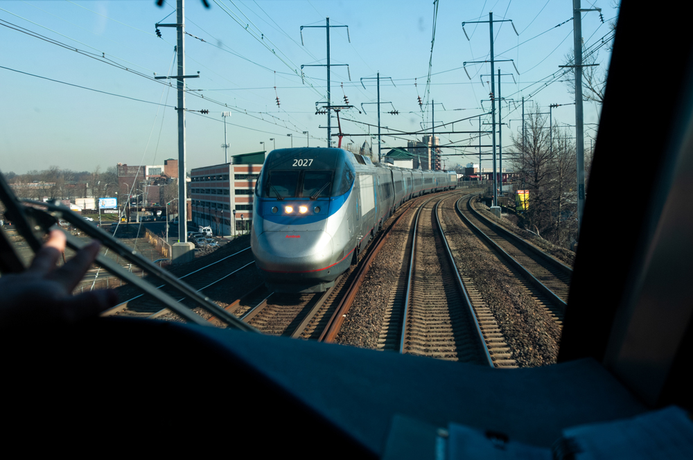 picture of one train out of the cab of another