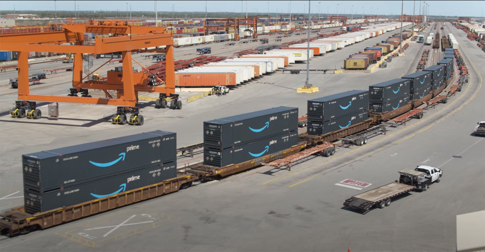 Intermodal cars at terminal with blue Amazon containers