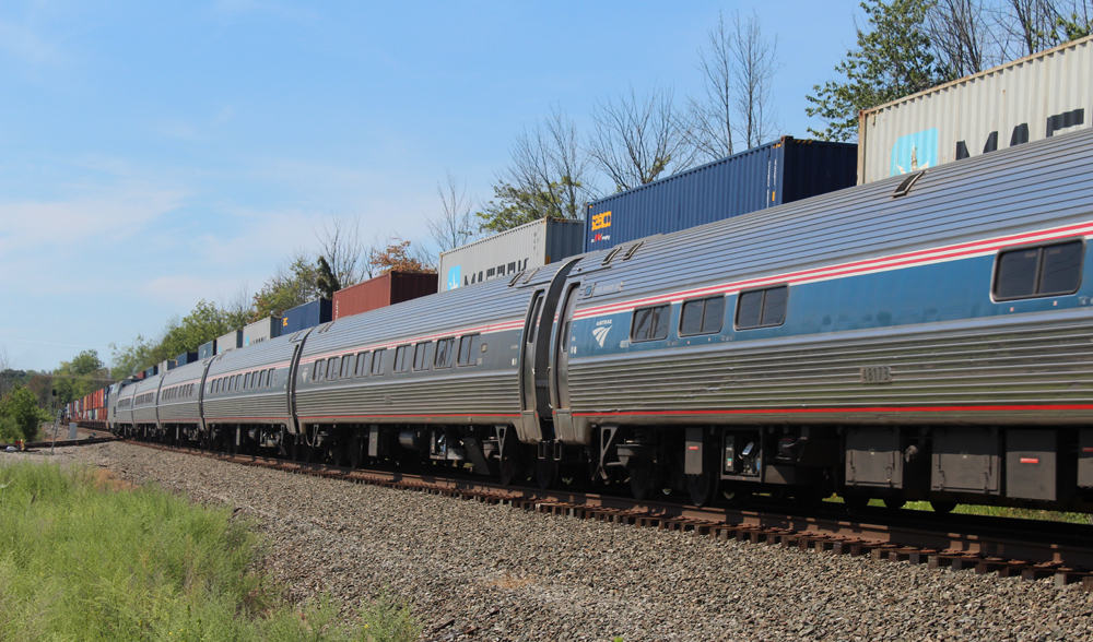 Going away shot of passenger train and freight