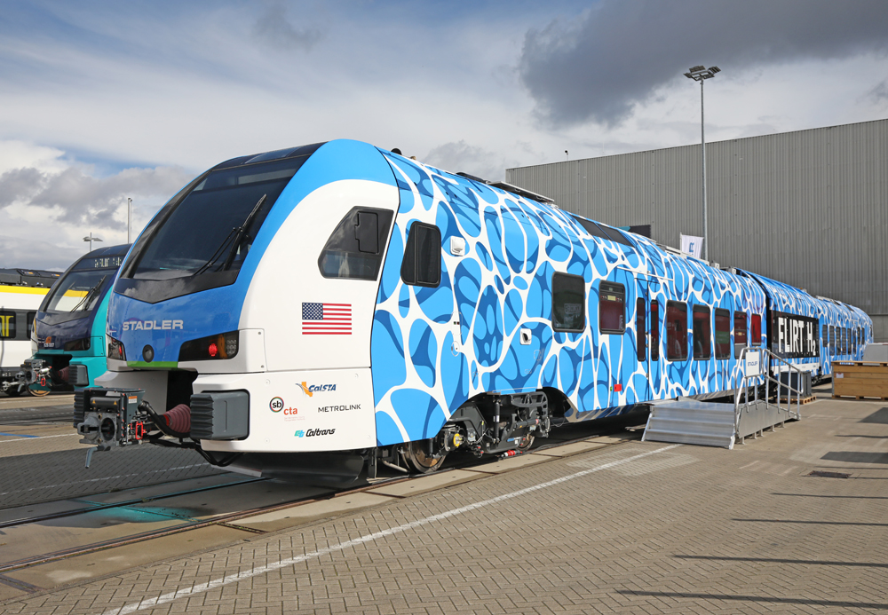 Blue and white two-car passenger trainset on display track