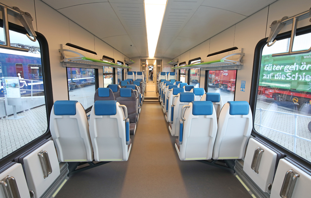 Interior of passenger equipment, with two seats on either side of aisle
