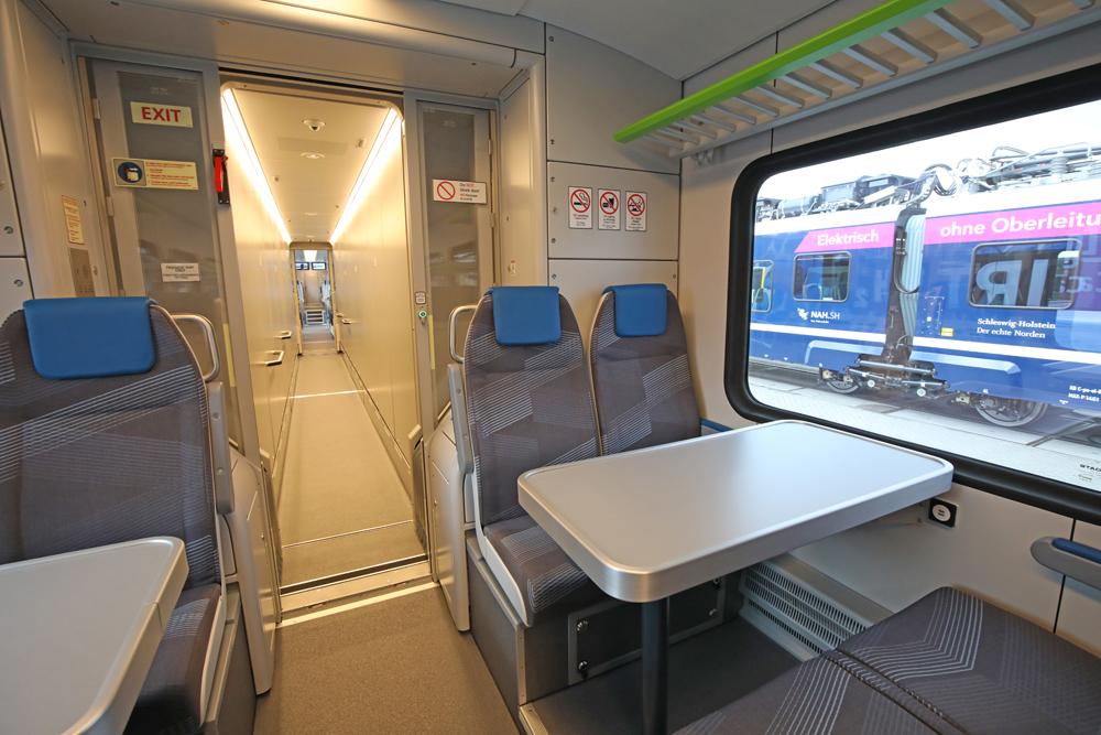 Interior of train looking down long center corridor