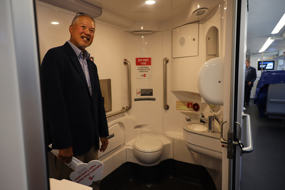 Man in bathroom of passenger train