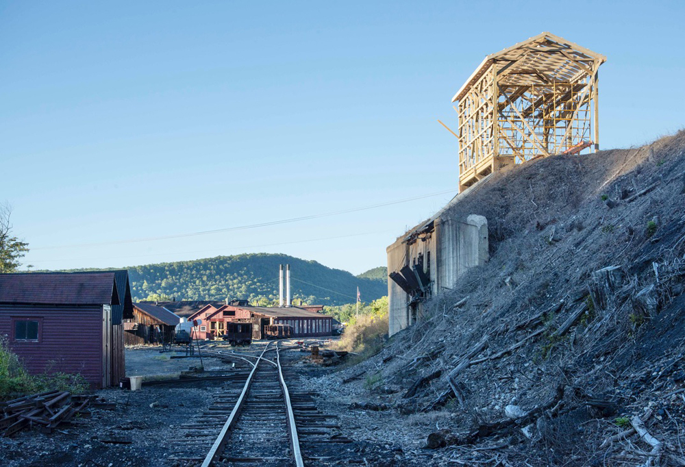 Wooden framework for building on hillside overlooks railroad track