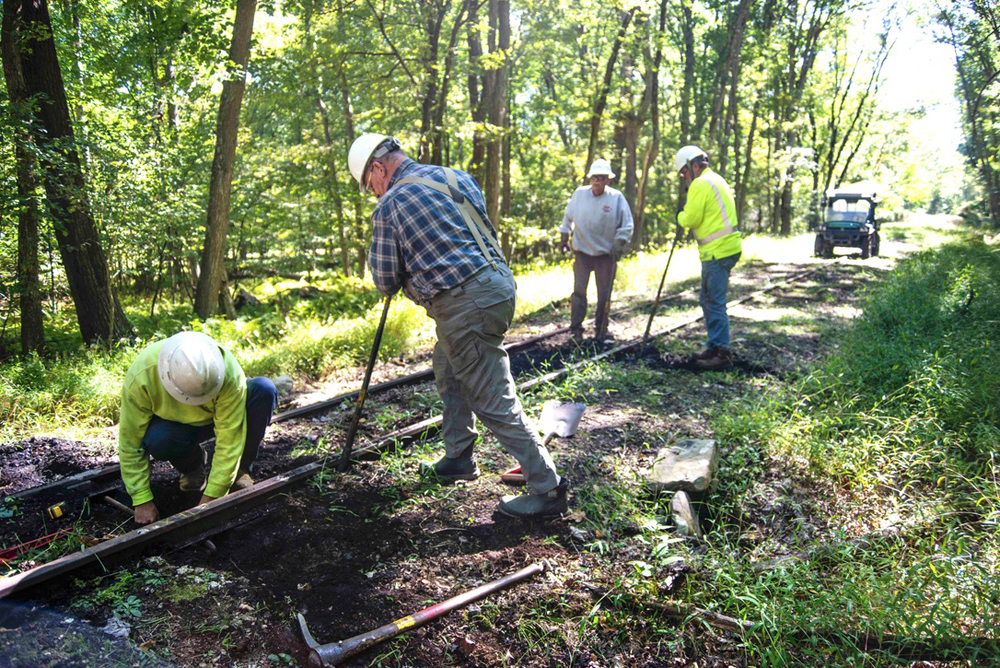 Men working on railroad track with hand tools