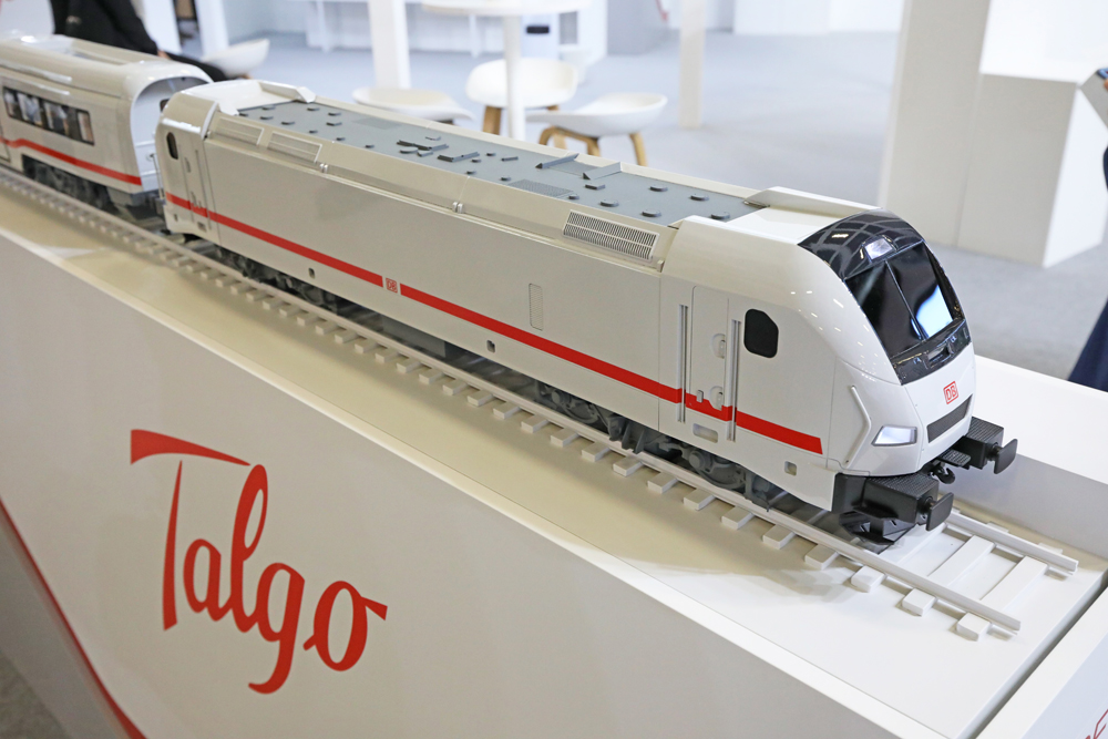 Model of white passenger locomotive with red stripe