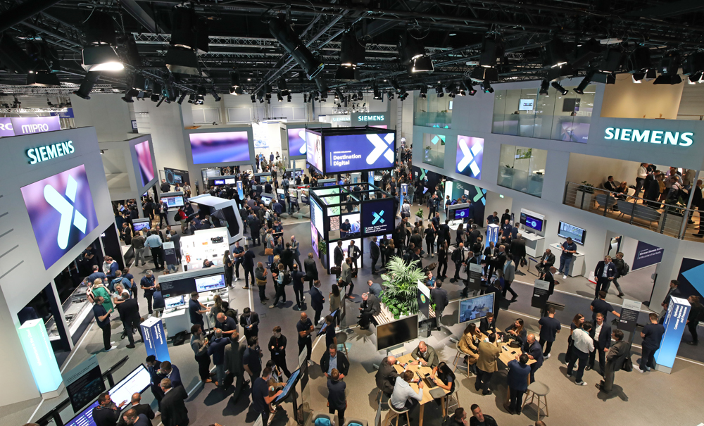 View from above of large, crowded display area for one company at trade show