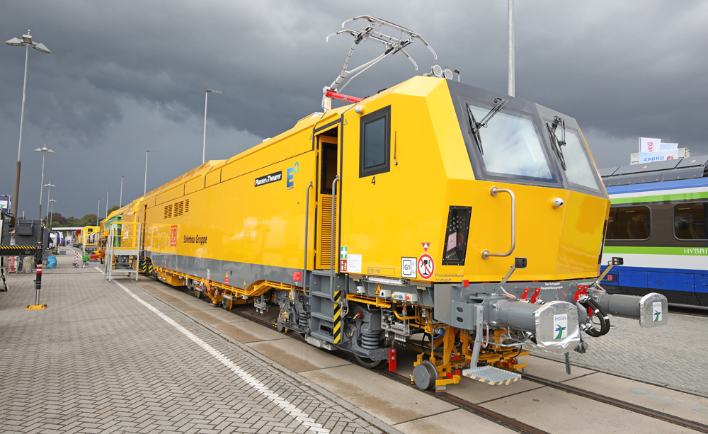 Boxy yellow maintenance machine under threatening clouds