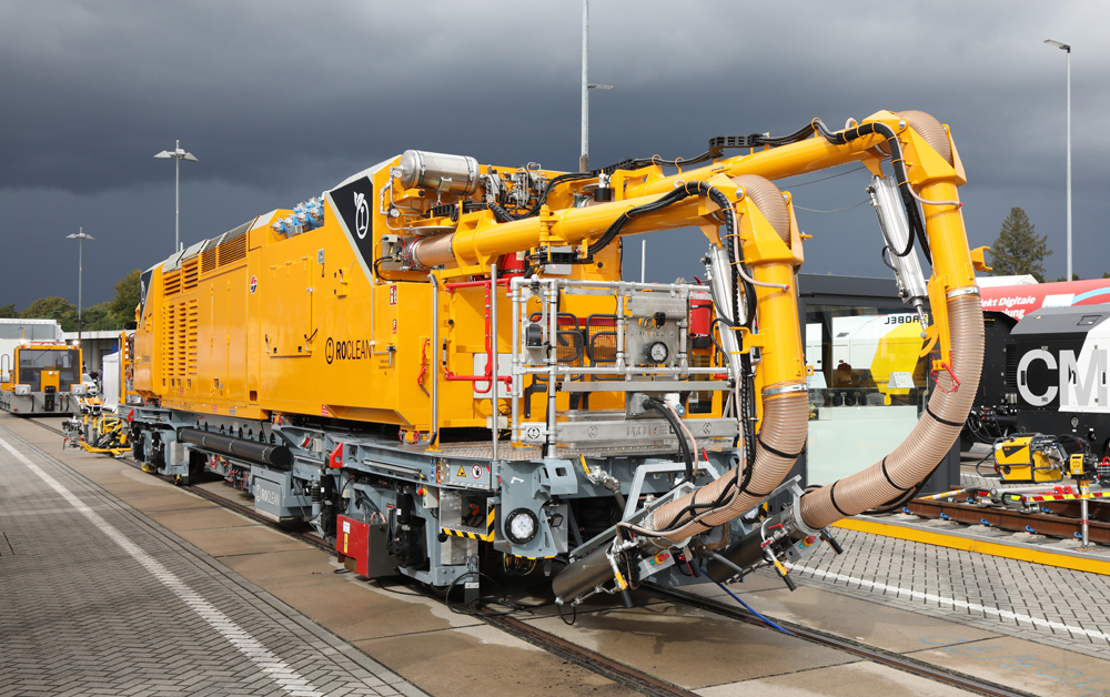 Yellow maintenance machine with two large hoses in front, looking a bit like tusks