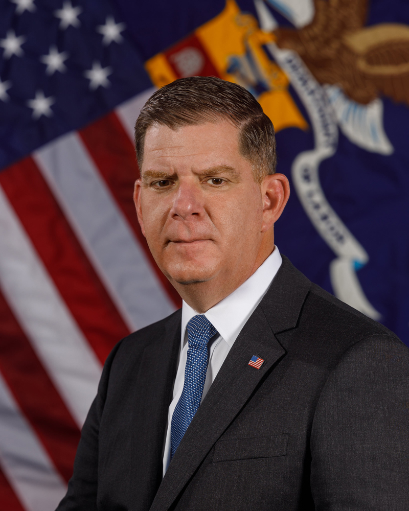 Portrait of man in front of U.S. flag