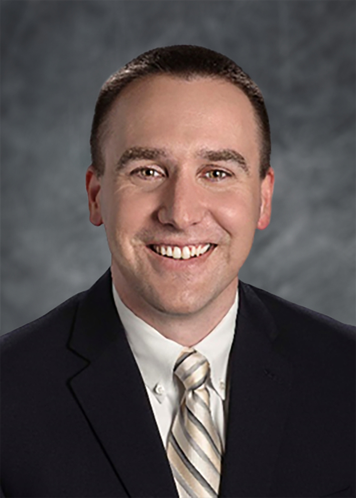 Head shot of smiling man in coat and tie