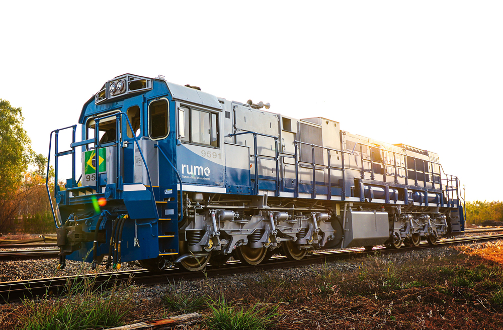 Blue and gray end-cab locomotive with three-axle trucks