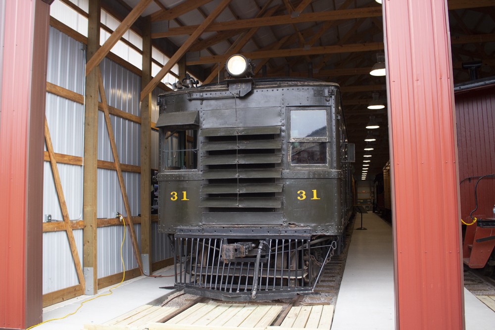 Green railcar inside building