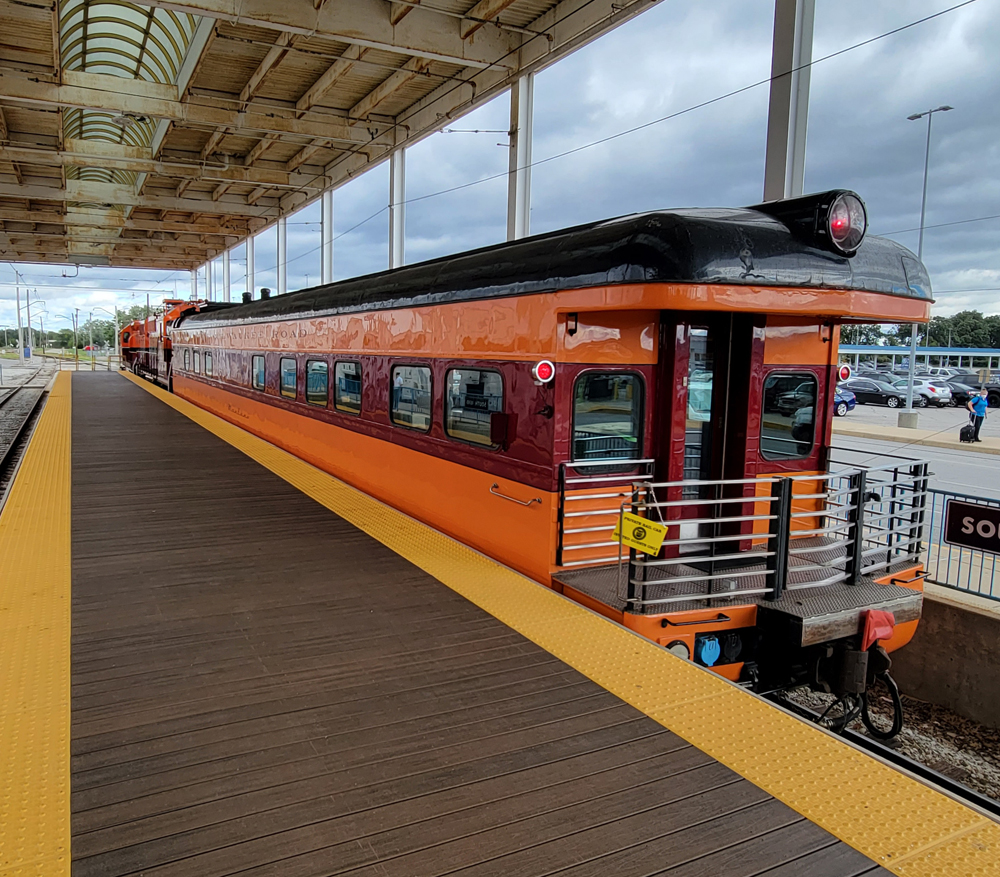 Orange and maroon private car with observation platform