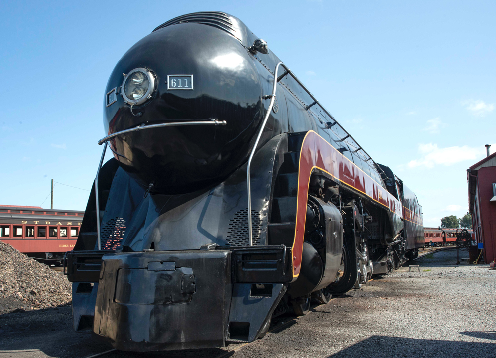 Black streamlined steam locomotive with red trim
