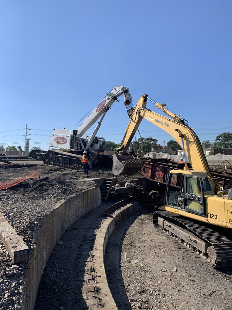 Construction equipment removing turntable from pit