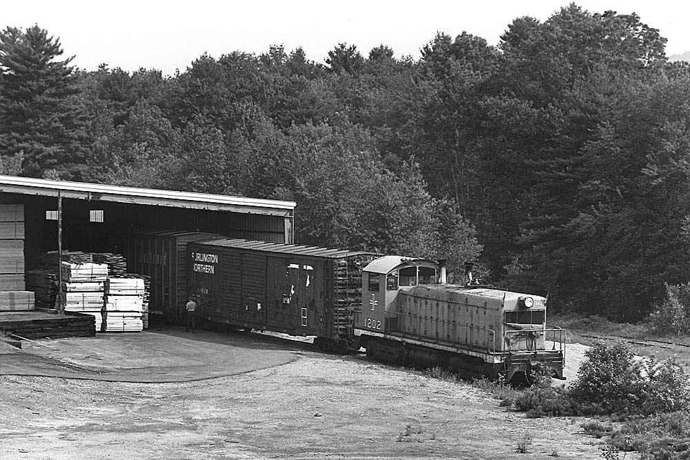 Diesel locomotive moving railcars out of building