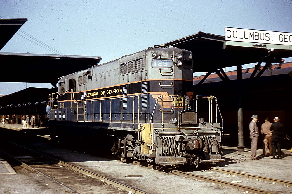 Colorful Central of Georgia locomotive passing through station without train