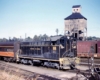 Diesel switching locomotive in front of coaling tower