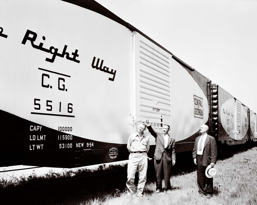 Men stand by new, clean Central of Georgia Railway boxcars