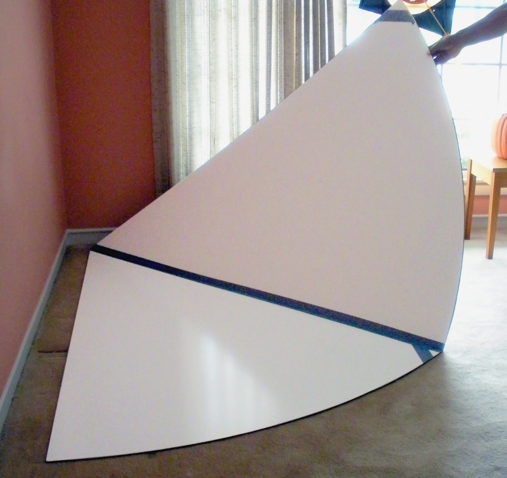 hand holding two pieces of hardboard