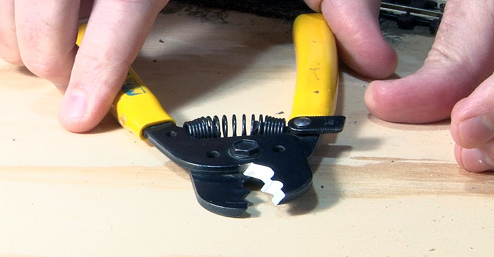 Metal wire-cutting tool with yellow plastic handles