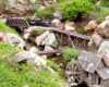 model steam engine on bridge in garden railway