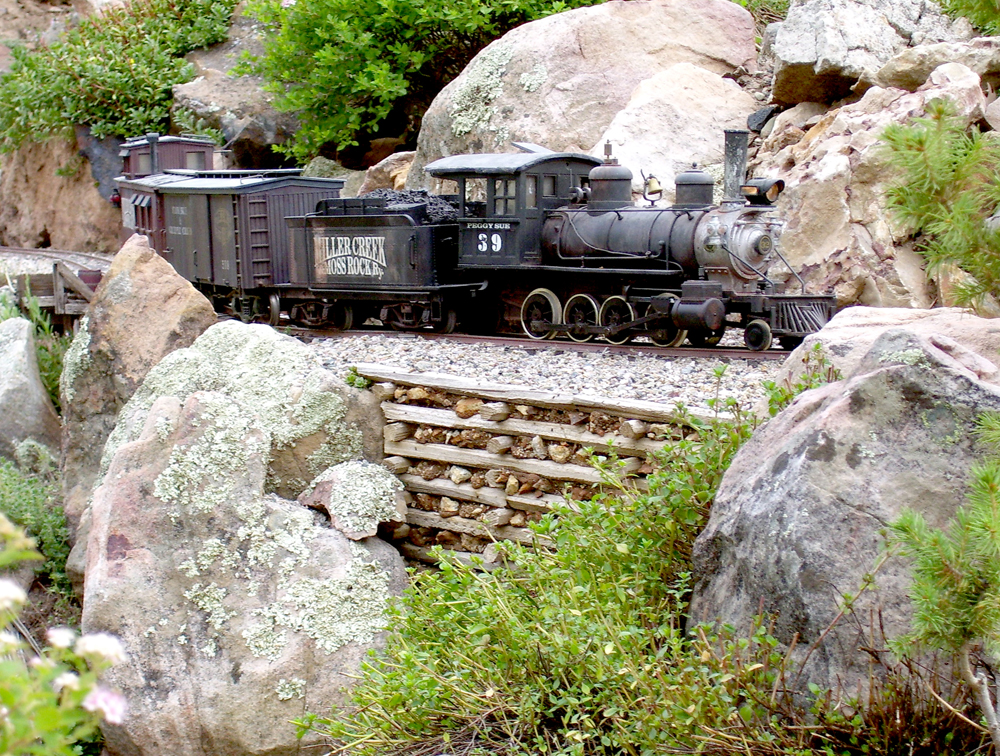 model steam engine on track near cribbing