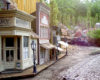 close up of model buildings with steam train in the distance