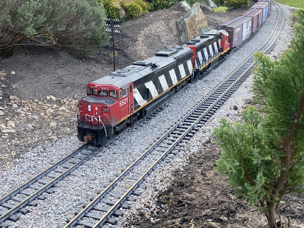 red, black, and white model diesel on track
