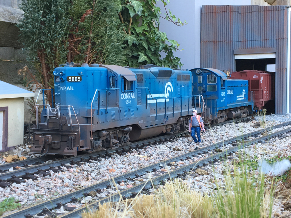 blue model diesel engines with figure on garden railway